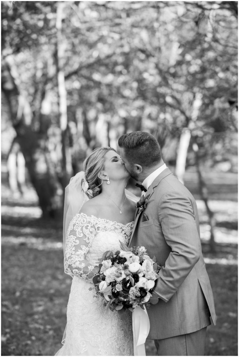 Newly married couple kiss at The Oaks in St. Michaels, MD by Melissa Grimes-Guy Photography
